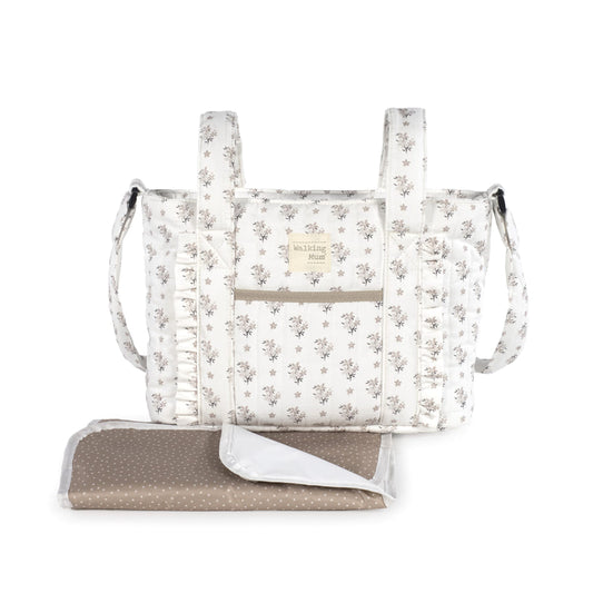 Visione frontale di borsa fasciatoio color panna e con dettagli floreali rosa e beige. con fasciatoio incluso