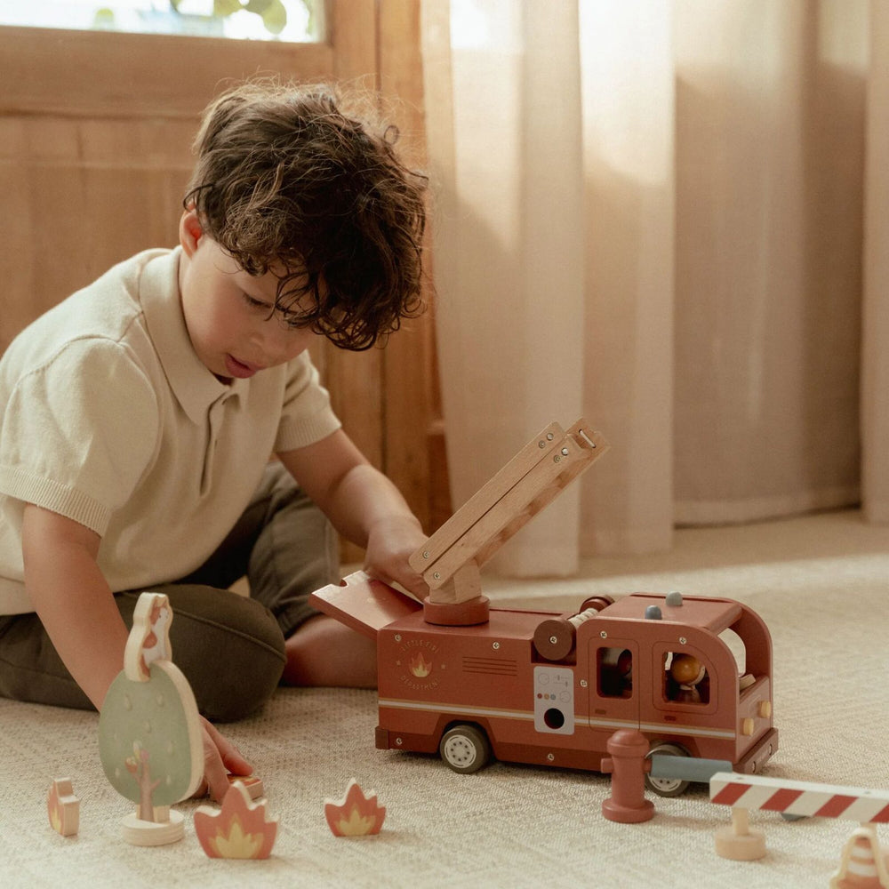 bimbo che gioca con camion pompiere