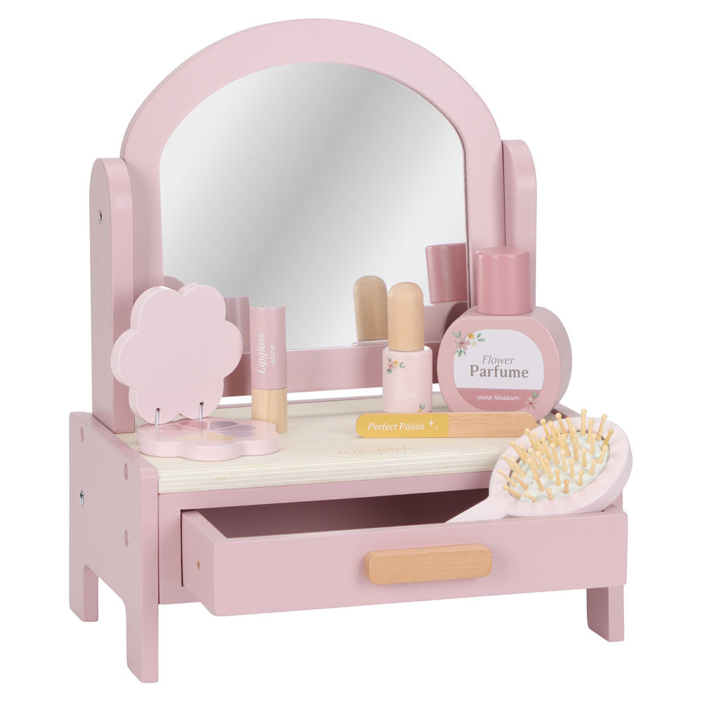 Dressing table, tavolino da trucco rosa con specchio rotante, cassetto aperto con spazzola, ombretto, rossetto, smalto profumo e lima per unghie, tutti in legno