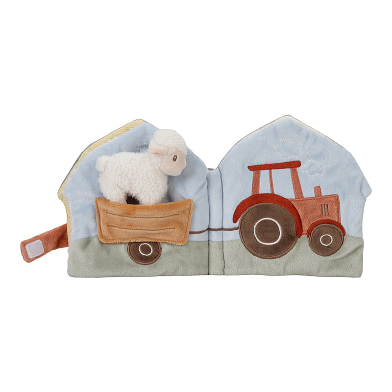 Libretto morbido aperto con pecorella su carretto trainato da trattore