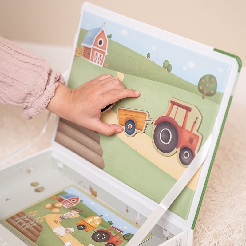Immagine ambientata di bimba che attacca un magnete sulla base da gioco di Little Dutch